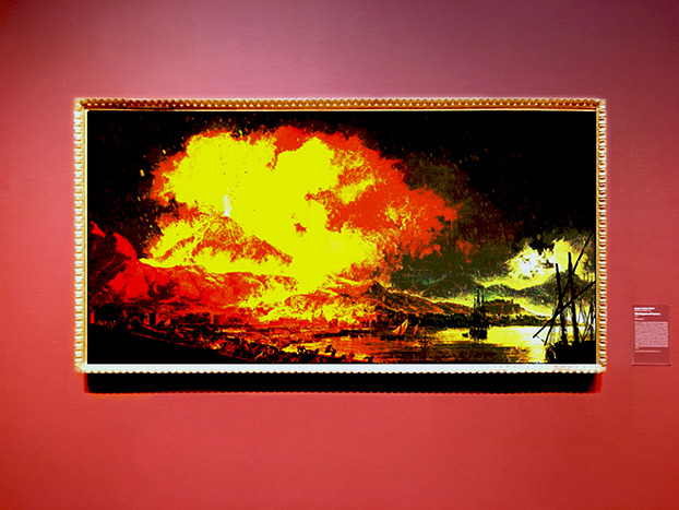 Pierre-Jacques Volaire's The Eruption of Vesuvius, recoloured in burning yellow and red, hanging in a gallery